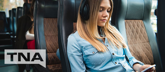 Reading and listening to music on comfortable luxury chartered bus